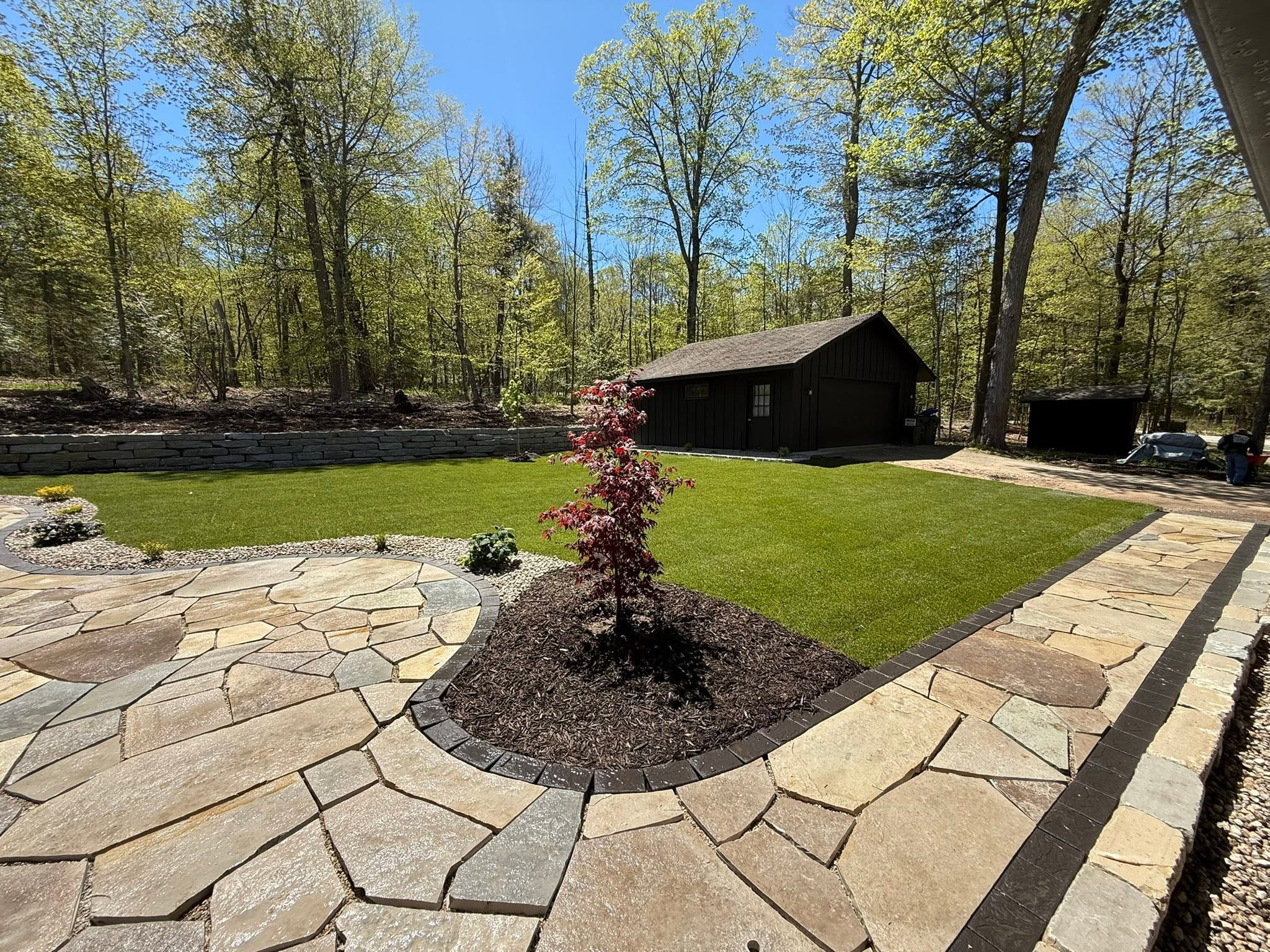 Finished natural stone and lawn landscape project